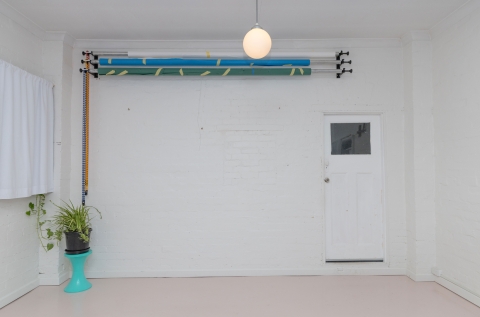 Wall-mounted paper roll backdrop rack